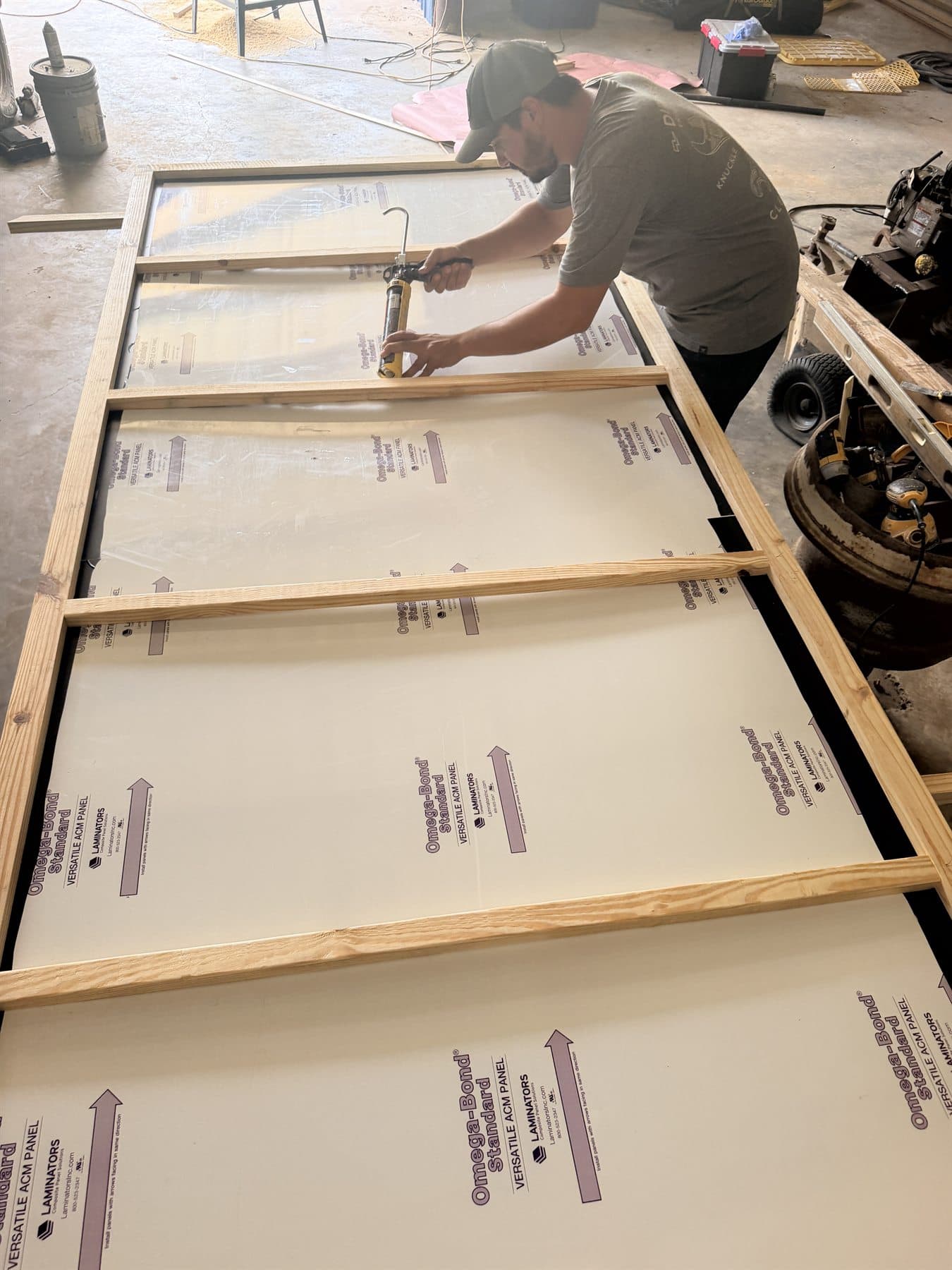 Alpha contractor building a wood frame for a commercial sign panel