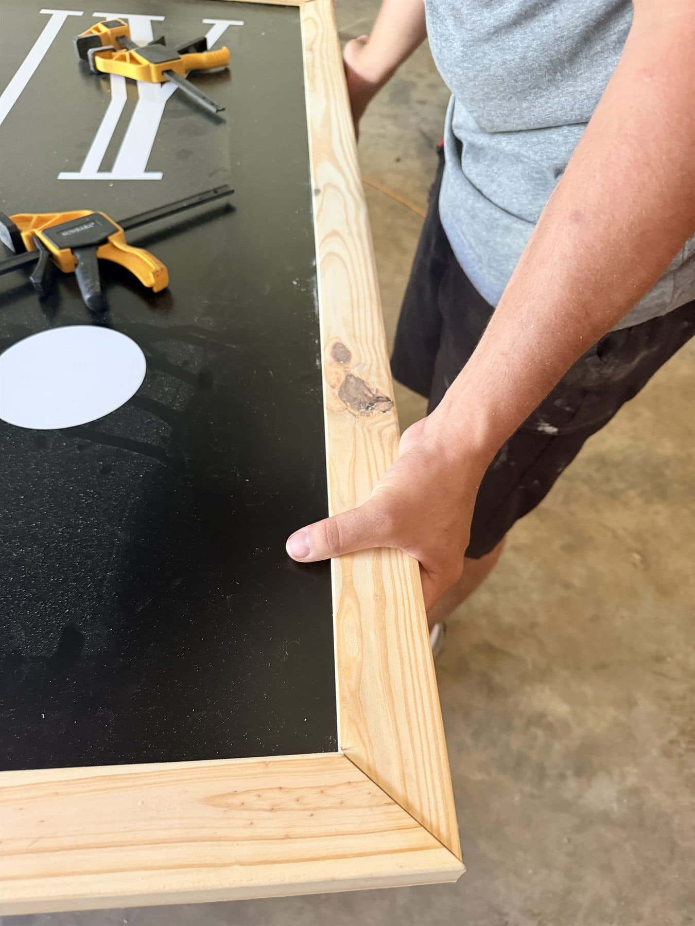 Alpha fitting the wood frame around a commercial sign panel