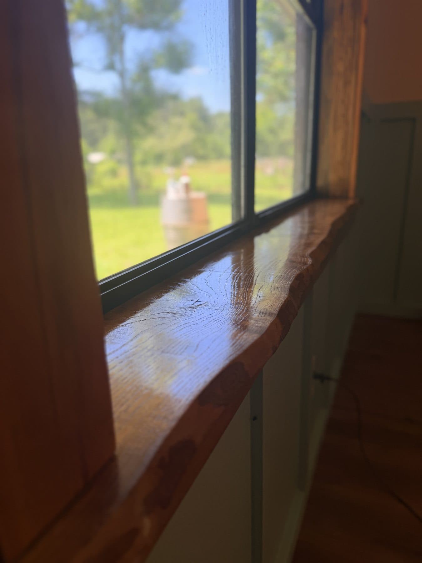 Close detail of finished live edge wood grain on a custom windowsill