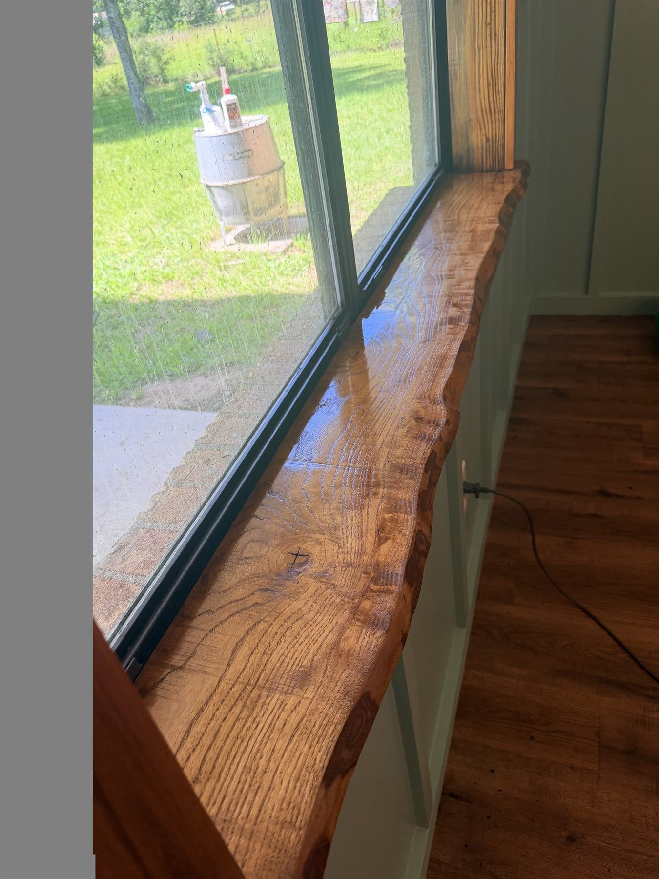 Finished custom live edge wood windowsill in a residential remodel