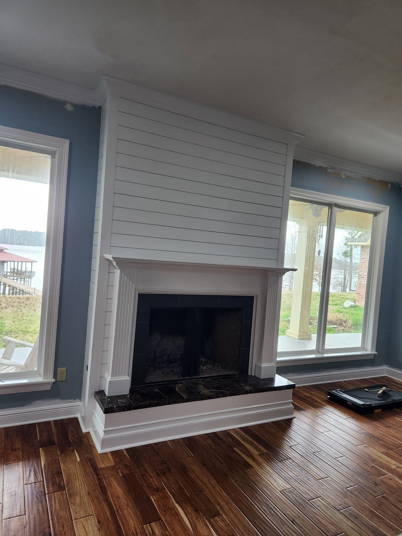 Completed custom fireplace remodel with shiplap paint and tile