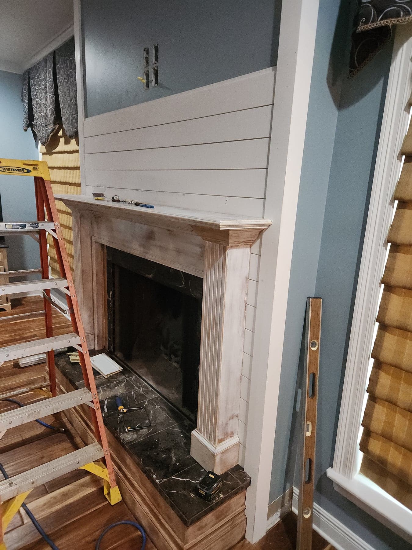 Shiplap installation in progress during custom fireplace remodel